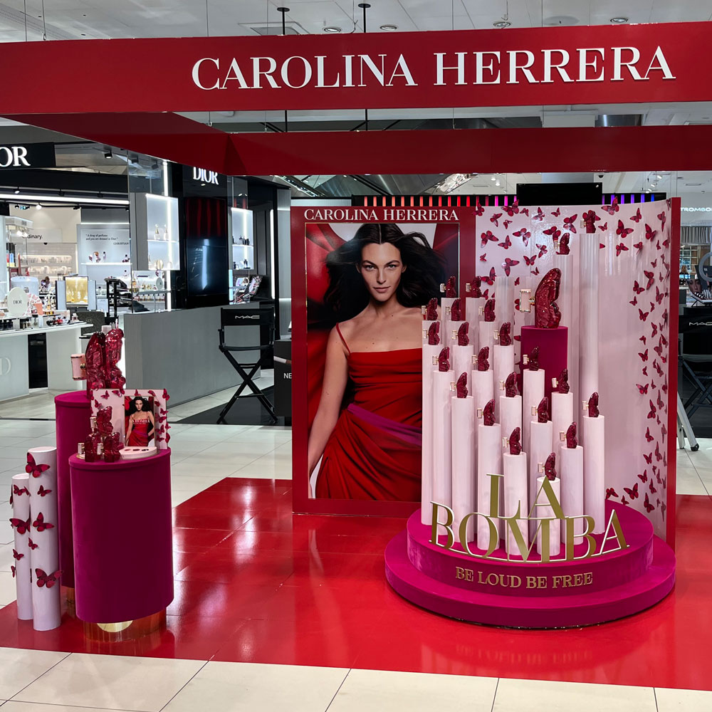 Carolina Herrera La Bomba retail display with butterflies and model.